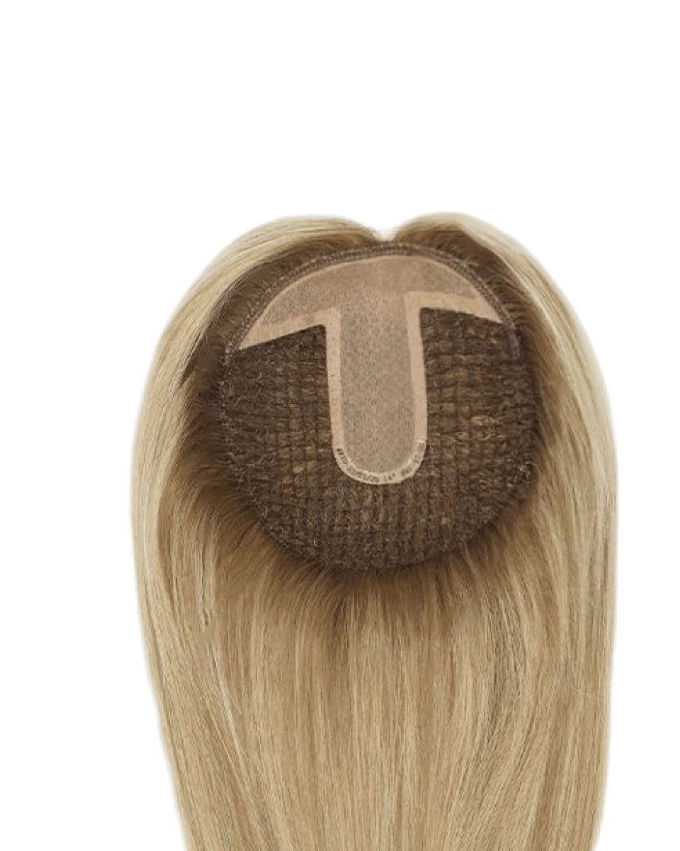 Underside view of a blonde integration hairpiece showing its base design